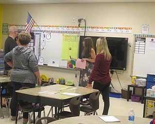 Neighbors | Zack Shively  .Instructor Amy Iacofano had a conversation with some parents after her presentation at Austintown Elementary's open house.