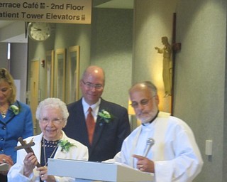 Neighbors | Zack Shively  .Father George Gage of St. Mary Romanian Catholic Church gave Sr. Margaret Mary Siegfried H.M. a gift. He also blessed the pharmacy and led prayer. Pictured are, (front) Seigfried, Gage; (back) Genie Aubel, president of St. Elizabeth Boardman, and  Paul Homick, Jr., president of the Mercy Health Foundation Mahoning Valley and interim vice president of mission integration for Mercy Health.