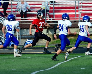 Neightbors | Submitted .Canfield Village Middle School’s Broc Lowry sprinted by Poland Bulldog defenders. Lowry made a 92 yeard touchdown during game.