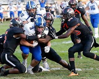 MICHAEL G TAYLOR | THE VINDICATOR- 09-15-17 FOOTBALL Poland Bulldogs vs Howland Tigers at Howland High School, Warren, OH.1st qtr., Poland's #3 Jonah Spencer takes the ball to the Howland 2 yard line as Howland tacklers #5 Williams Hines (right), #1 Samari Dean (middle) and #20 Ja'whan Dean bring him down.