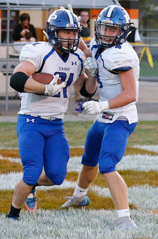 MICHAEL G TAYLOR | THE VINDICATOR- 09-15-17 FOOTBALL Poland Bulldogs vs Howland Tigers at Howland High School, Warren, OH.2nd qtr., Poland's #21 Dante Romano celebrates his td run with his teammate #4 Mike Diaz