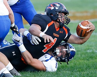 MICHAEL G TAYLOR | THE VINDICATOR- 09-15-17 FOOTBALL Poland Bulldogs vs Howland Tigers at Howland High School, Warren, OH.1st qtr., Howland's #4 Jackson Deemer stretches for extra yardage as Poland's #5 Eric Shipsky makes the stop.