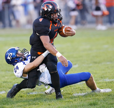 MICHAEL G TAYLOR | THE VINDICATOR- 09-15-17 FOOTBALL Poland Bulldogs vs Howland Tigers at Howland High School, Warren, OH.2nd qtr., after picking up a 1st down, Howland's #4 Jackon Deemer is brought down by Poland's #24 Billy Orr