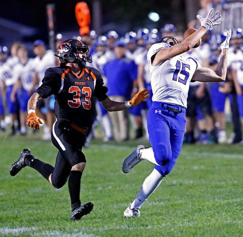 MICHAEL G TAYLOR | THE VINDICATOR- 09-15-17 FOOTBALL Poland Bulldogs vs Howland Tigers at Howland High School, Warren, OH.2nd qtr., Poland's #15 Nate Alessi attempts to malke the catch as  Howland's #33 Jon Elliot defends.