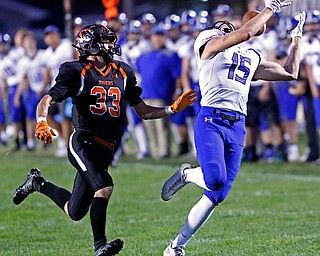 MICHAEL G TAYLOR | THE VINDICATOR- 09-15-17 FOOTBALL Poland Bulldogs vs Howland Tigers at Howland High School, Warren, OH.2nd qtr., Poland's #15 Nate Alessi attempts to malke the catch as  Howland's #33 Jon Elliot defends.