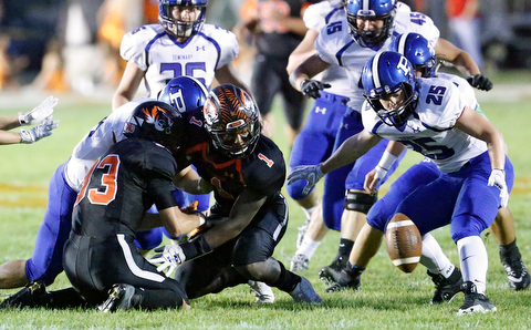 MICHAEL G TAYLOR | THE VINDICATOR- 09-15-17 FOOTBALL Poland Bulldogs vs Howland Tigers at Howland High School, Warren, OH.2nd qtr., Howland's #33 Jon Elliot fumbles the punt return as Poland's #25 M.J. Farber attempts to malke the recovery.
