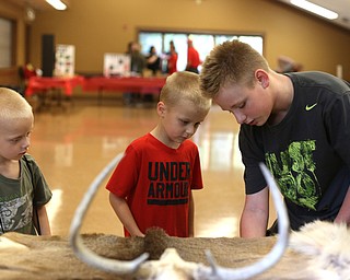 (from left) Brothers; Jayden(5), Colton(7) and Seth(12) Barnhouse of East Liverpool inspect different animal pelts during the annual Outdoor Family Fun Day, Saturday, Sept. 16, 2017, at Boardman Park in Boardman. The Barnhouse family drives up every year to attend the event...(Nikos Frazier | The Vindicator)..
