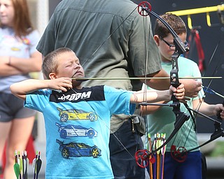 Michael Short(8) of Boardman lines up his shot with a bow and arrow during the annual Outdoor Family Fun Day, Saturday, Sept. 16, 2017, at Boardman Park in Boardman...(Nikos Frazier | The Vindicator)..