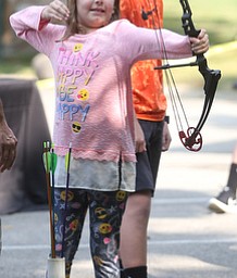 Katie Short(10) of Boardman lines up her shot with a bow and arrow during the annual Outdoor Family Fun Day, Saturday, Sept. 16, 2017, at Boardman Park in Boardman...(Nikos Frazier | The Vindicator)..