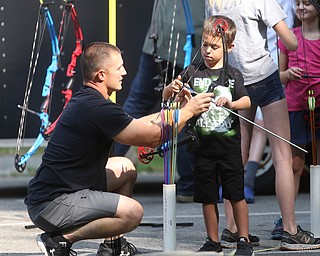Owen Carothers(6) of Hermitage, Pa. lines up his shot with a bow and arrow with the help of On Target volunteer, Jason Austin during the annual Outdoor Family Fun Day, Saturday, Sept. 16, 2017, at Boardman Park in Boardman...(Nikos Frazier | The Vindicator)..