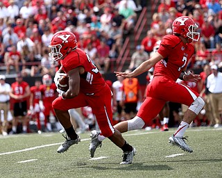 Youngstown State University quarterback Nathan Mays (7) hands off to Youngstown State University tail back Braxton Chapman (3) in the first quarter as Youngstown State takes on Central Connecticut State, Saturday, Sept. 16, 2017, at Stambaugh Stadium in Youngstown. Youngstown State won 59-9...(Nikos Frazier | The Vindicator)..