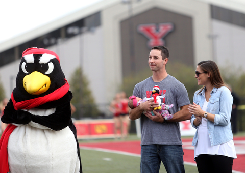 Tommie Zetts(left) stands with his wife, Brittany and newborn daughter, Mariella(4 days old) as he is inducted into the Youngstown State University Athletics Hall of Fame in the first quarter as Youngstown State takes on Central Connecticut State, Saturday, Sept. 16, 2017, at Stambaugh Stadium in Youngstown. Youngstown State won 59-9...(Nikos Frazier | The Vindicator)..