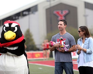Tommie Zetts(left) stands with his wife, Brittany and newborn daughter, Mariella(4 days old) as he is inducted into the Youngstown State University Athletics Hall of Fame in the first quarter as Youngstown State takes on Central Connecticut State, Saturday, Sept. 16, 2017, at Stambaugh Stadium in Youngstown. Youngstown State won 59-9...(Nikos Frazier | The Vindicator)..