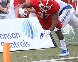 Youngstown State University tail back Tevin McCaster (37) dives into the end zone for a touchdown as Central Connecticut State University Blue Devils safety Najae Brown (13) attempts to tackle him out of bounds in the first quarter as Youngstown State takes on Central Connecticut State, Saturday, Sept. 16, 2017, at Stambaugh Stadium in Youngstown. Youngstown State won 59-9...(Nikos Frazier | The Vindicator)..