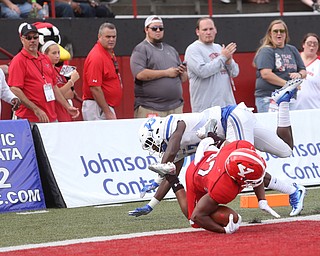 Youngstown State University tail back Tevin McCaster (37) dives into the end zone for a touchdown as Central Connecticut State University Blue Devils safety Najae Brown (13) attempts to tackle him out of bounds in the first quarter as Youngstown State takes on Central Connecticut State, Saturday, Sept. 16, 2017, at Stambaugh Stadium in Youngstown. Youngstown State won 59-9...(Nikos Frazier | The Vindicator)..