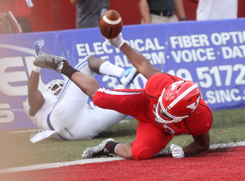 Youngstown State University tail back Tevin McCaster (37) dives into the end zone for a touchdown as Central Connecticut State University Blue Devils safety Najae Brown (13) attempts to tackle him out of bounds in the first quarter as Youngstown State takes on Central Connecticut State, Saturday, Sept. 16, 2017, at Stambaugh Stadium in Youngstown. Youngstown State won 59-9...(Nikos Frazier | The Vindicator)..