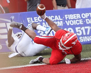 Youngstown State University tail back Tevin McCaster (37) dives into the end zone for a touchdown as Central Connecticut State University Blue Devils safety Najae Brown (13) attempts to tackle him out of bounds in the first quarter as Youngstown State takes on Central Connecticut State, Saturday, Sept. 16, 2017, at Stambaugh Stadium in Youngstown. Youngstown State won 59-9...(Nikos Frazier | The Vindicator)..