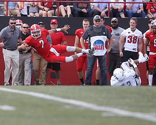 Youngstown State University quarterback Nathan Mays (7) leaps out of bounds as Central Connecticut State University Blue Devils linebacker Michon Hunt (32) rolls in the corner in the first quarter as Youngstown State takes on Central Connecticut State, Saturday, Sept. 16, 2017, at Stambaugh Stadium in Youngstown. Youngstown State won 59-9...(Nikos Frazier | The Vindicator)..
