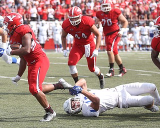 Youngstown State University tail back Tevin McCaster (37) runs as Central Connecticut State University Blue Devils safety Kyle Baum (12) tries to hold onto his shoe in the second quarter as Youngstown State takes on Central Connecticut State, Saturday, Sept. 16, 2017, at Stambaugh Stadium in Youngstown. Youngstown State won 59-9...(Nikos Frazier | The Vindicator)..