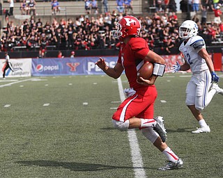 Youngstown State University quarterback Nathan Mays (7) runs into the end zone for a touchdown as he is pursued by Central Connecticut State University Blue Devils safety Kyle Baum (12) in the second quarter as Youngstown State takes on Central Connecticut State, Saturday, Sept. 16, 2017, at Stambaugh Stadium in Youngstown. Youngstown State won 59-9...(Nikos Frazier | The Vindicator)..