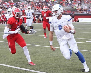 Central Connecticut State University Blue Devils quarterback Jacob Dolegala (9) runs out of bounds as he is pursued by Youngstown State University tail back Braxton Chapman (3) in the third quarter as Youngstown State takes on Central Connecticut State, Saturday, Sept. 16, 2017, at Stambaugh Stadium in Youngstown. Youngstown State won 59-9...(Nikos Frazier | The Vindicator)..