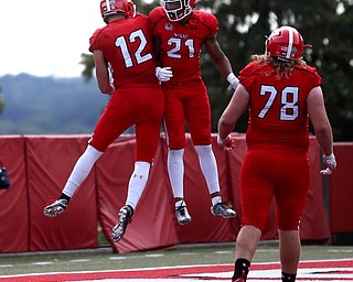 Youngstown State University wide receiver Ricky Davis (12) and Youngstown State University defensive end Jamal Smith (21) celebrate Davis's touchdown in the fourth quarter as Youngstown State takes on Central Connecticut State, Saturday, Sept. 16, 2017, at Stambaugh Stadium in Youngstown. Youngstown State won 59-9...(Nikos Frazier | The Vindicator)..