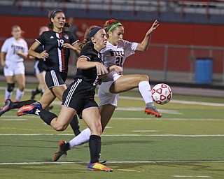 Austintown Fitch's Lauren Dolak (21) fights with Canfield's Ally Stein (24) for the ball during the first half of Monday night's matchup at Fitch High School.   Dustin Livesay  |  The Vindicator  9/18/17  Fitch.