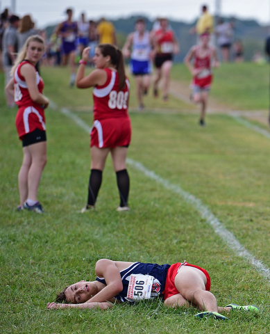 A runner for Austintown Fitch lies in the grass after going down during the 2017 Suburban League Championship, Tuesday afternoon at the Canfield Fair Grounds. DAVID DERMER | THE VINDICATOR..I don't have any ID for him. He did not finish and was not on the result sheet.