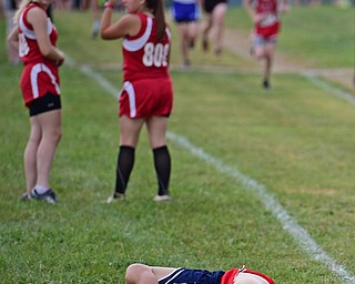 A runner for Austintown Fitch lies in the grass after going down during the 2017 Suburban League Championship, Tuesday afternoon at the Canfield Fair Grounds. DAVID DERMER | THE VINDICATOR..I don't have any ID for him. He did not finish and was not on the result sheet.