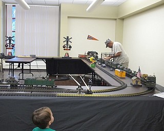 Neighbors | Alexis Bartolomucci.Children watched a member of the Riverside Railroad Club set up the model train display at the Boardman library on Aug. 4 and 5.