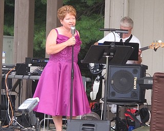 Neighbors | Zack Shively  .Caryn Dettling sang a famous swing song on Aug. 10 when Glass City Swing Band performed at Boardman Park's Music in the Park series.