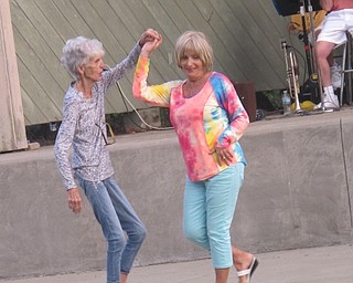 Neighbors | Zack Shively  .Two women danced while the Jim Frank Combo played a polka song at Austintown Park's Concert in the Park on Aug. 16.