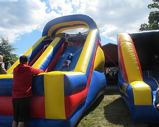 Neighbors | Zack Shively  .Poland United Methodist Church provided the community children with inflatable slides and a bounce castle for their Family Fun Carnival.