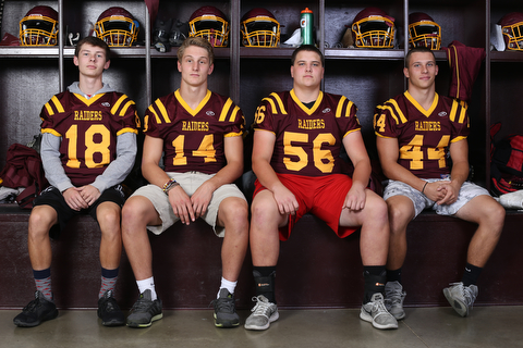 (from left)South Range wide receiver Mathias Combs (18), South Range quarterback Aniello Buzzacco (14), South Range offensive lineman Matt Brooks (56) and South Range running back Peyton Remish (44) pose for a portrait, Tuesday, Sept. 19, 2017, in the team's locker room at South Range High School in Canfield. ..(Nikos Frazier | The Vindicator)