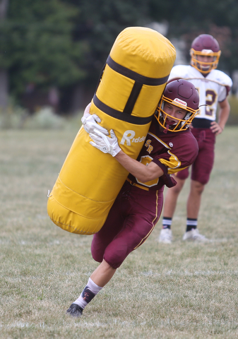 South Range wide receiver Mathias Combs (18) tackles a dummy during a weekday practice, Tuesday, Sept. 19, 2017, at South Range High School in Canfield. ..(Nikos Frazier | The Vindicator)