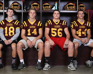 (from left)South Range wide receiver Mathias Combs (18), South Range quarterback Aniello Buzzacco (14), South Range offensive lineman Matt Brooks (56) and South Range running back Peyton Remish (44) pose for a portrait, Tuesday, Sept. 19, 2017, in the team's locker room at South Range High School in Canfield. ..(Nikos Frazier | The Vindicator)