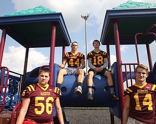 (from left) South Range offensive lineman Matt Brooks (56), South Range running back Peyton Remish (44), South Range wide receiver Mathias Combs (18) and South Range quarterback Aniello Buzzacco (14) pose for a portrait, Tuesday, Sept. 19, 2017, on a school playground at South Range High School in Canfield. ..(Nikos Frazier | The Vindicator)