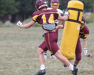 South Range quarterback Aniello Buzzacco (14) runs with a tackle dummy for South Range wide receiver Mathias Combs (18) to tackle during a weekday practice, Tuesday, Sept. 19, 2017, at South Range High School in Canfield. ..(Nikos Frazier | The Vindicator)
