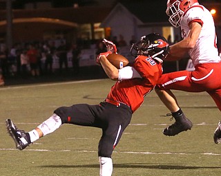 Canfield wide receiver Dean Cutrer(10) and Struthers defensive back Nick Adams(2) jump up for the pass intended for Cutrer in the first half as Struthers takes on Canfield, Friday, Sept. 22, 2017, at Canfield High School in Canfield. ..(Nikos Frazier | The Vindicator)..