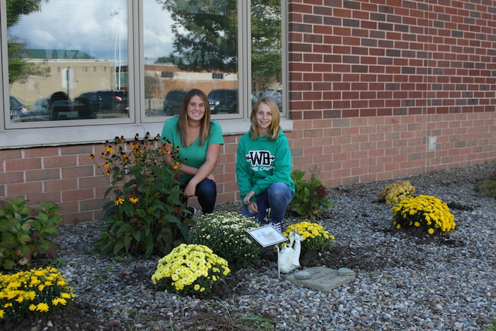 The school year at West Branch Middle School began with the student council officers’ annual planting of mums in the Jennifer Baker Memorial Garden outside the school. The garden is filled with a variety of flowers and shrubs, but the planting of yellow mums has quickly become a welcome tradition. Baker was a teacher at West Branch until she died in an automobile accident Nov. 19, 2009. This is one of the many service projects the WBMS student council conducts throughout the school year. Above, from left, are WBMS Student Council officers Peyton Bell, president, and Kennedy Close, vice president, planting mums.