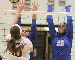 William D. Lewis The Vindicator Hubbard's Kristina Fahndrich(15) and Nya Thornton(20 block a shot from Boardman's Ashley Clark(30) during 9-26-17 action at Boardman.
