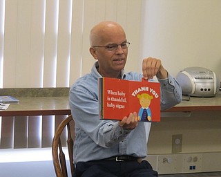 Neighbors | Zack Shively.The Boardman library's John Youngling read babies a pop-up book on Aug. 8 at Bonding with Babies and Books.
