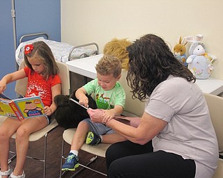 Neighbors | Zack Shivelyv.Parents and children read books at Bonding with Babies and Books at the Boardman library on Aug. 8.