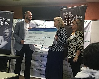 Neighbors | Submitted.As part of the 10th anniversary celebration of St. Elizabeth Boardman Hospital, the hospital’s employees made a financial contribution to the Rescue Mission of Mahoning Valley’s Move the Mission Capital Campaign. Pictured, during a check presentation ceremony on Aug. 8, are, from left, John Muckridge III, president and CEO of the Rescue Mission; Genie Aubel, president of St. Elizabeth Boardman Hospital, and Gina Mook, administrative assistant for St. Elizabeth Boardman Hospital and one of the leaders of employee giving activities for the hospital.