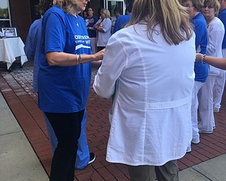Neighbors | Submitted.Genie Aubel, president of St. Elizabeth Boardman Hospital, shares blessing cards with staff during a ceremony on Aug. 9 to celebrate the 10th anniversary of the hospital.