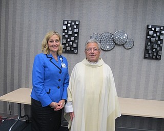 Neighbors | Zack Shively.President of St. Elizabeth Hospital Genie Aubel stood next to Father John Trimbur after the Anniversary Mass on Aug. 11 in the Azalea Room at St. Elizabeth Boardman Hospital.