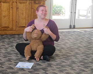 Neighbors | Zack Shively  .Librarian Mallory Wiand led the group in singing of "Come Along and Clap with Me" in the Austintown library on Aug. 15.
