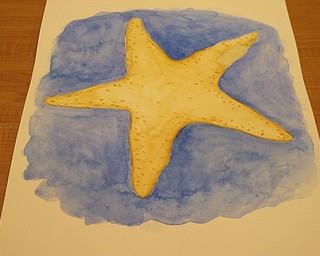 Neighbors | Zack Shively  .Instructor Andrea Zupcsan's example of painting of the water coloring painting the group made. Zupcsan provided the painters with a starfish stencil, paper, paint and utensils.