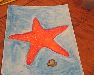 Neighbors | Zack Shively.Pictured is one of the paintings done at Watercoloring with Andrea at Austintown library on Aug. 23. The painters all drew starfish and designed them any way they wanted. This painter added a shell in the water.