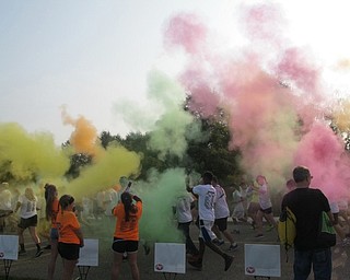 Neighbors | Zack Shively  .Volunteers covered the 5k runners with color powder during the Cam Jaros Color Run on Sept. 17. The community came together for the event to support 12-year-old Cameron Jaros, who was recently diagnosed with Acute B Cell Burkitts Leukemia. The event raised money to help his family pay for medical expenses for future treatments and hospital visits.